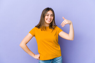 Fototapeta premium Young caucasian woman laughing about something, covering mouth with hands.