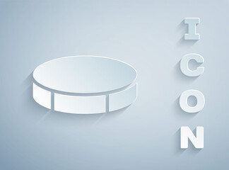Paper cut Hockey puck icon isolated on grey background. Sport equipment. Paper art style. Vector Illustration.