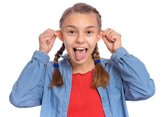 Beautiful crazy teenage girl makes funny face and sticks out tongue, plays fool, being in good...