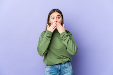 Young caucasian woman shocked covering mouth with hands.