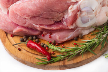 Raw pork knuckle with rosemary and pepper isolated on white background. Close-up.