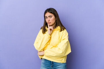 Young caucasian woman contemplating, planning a strategy, thinking about the way of a business.