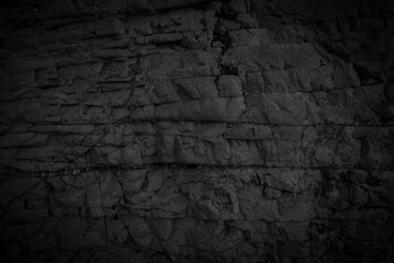 Dark tone fractured rock. Geological structure