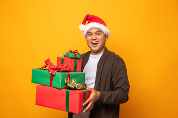 Happy excited asian man in new year's christmas day holding the
