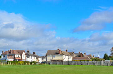 Fototapeta na wymiar Two-story houses near a football field on a sunny day.