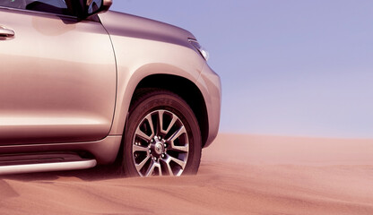 Plakat Close up of a golden car stuck in the sand in the Namib desert. Walvis Bay. Namibia. Africa 07.02.2020