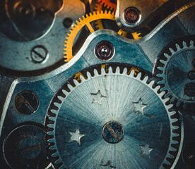 Vintage watch movement close - up. Selective focus on elements, macro photography. Background in steampunk style. Metallic grunge texture. Easy image tinting