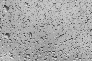 water drops on glass background texture. rain on the grey window