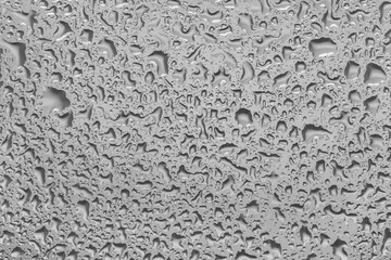 water drops on glass background texture. rain on the grey window