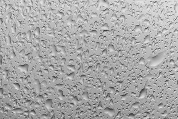 water drops on glass background texture. rain on the grey window