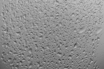 water drops on glass background texture. rain on the grey window