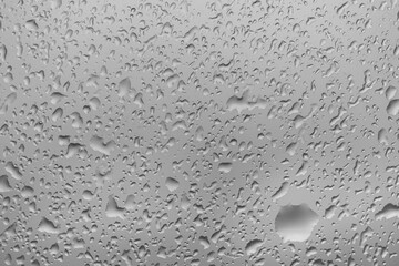 water drops on glass background texture. rain on the grey window