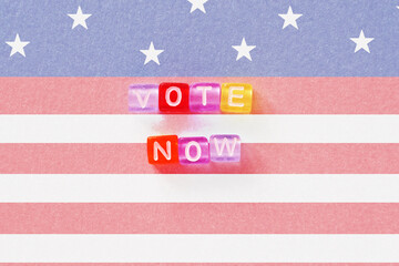 Presidental election day lettering. 2020 quote. American vote banner. USA flag background. Colorful phrase. Vote now slogan