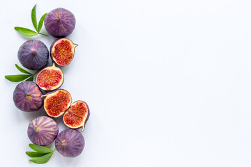 Tasty fresh figs cut in half with leaves, top view