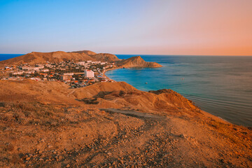 Panorama black sea coast landscape of Ordzhonikidze village in Crimea photographed at sunset from a high mountain