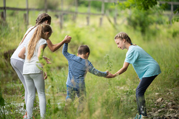 Group of kids walking on a field and having fun together