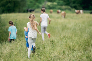Group of kids running around on a field and having fun together