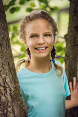 A young beautiful girl playing in the forest