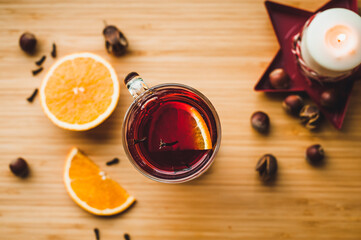 Red hot wine with spices, Christmas hot spicy drink. Seasonal mulled wine. Mulled wine with orange and cloves, selective focus.