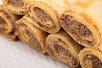 Meat stuffed crepes close-up. Macro shot.