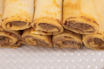Meat stuffed crepes close-up. Macro shot.