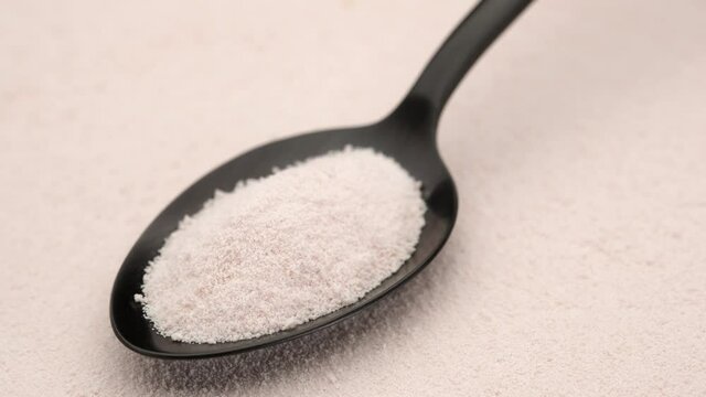 collagen powder in spoon on collagen powder background