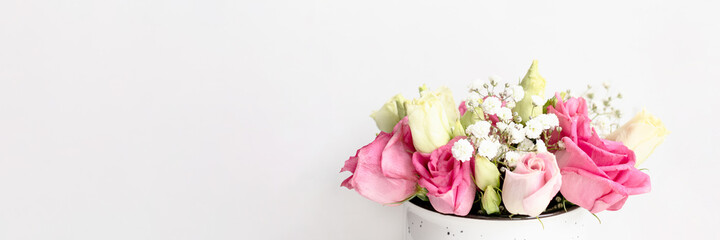Banner with bouquet of eustoma and gypsophila flowers on a white background. Spring concept with copy space.