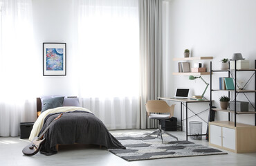 Modern teenager's room interior with workplace and bed
