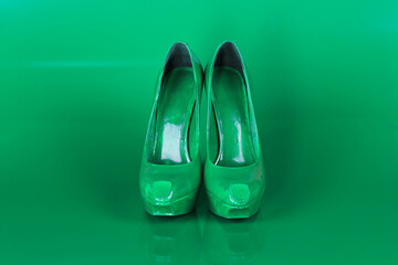 green women's shoes on a green background