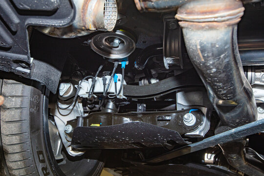 Detailed view of car undercarriage and exhaust system.