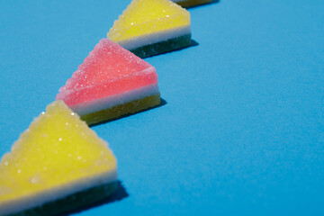 Triangular jelly candy on blue background.
