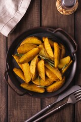 Delicious slices of baked potatoes with rosemary and oil