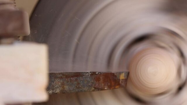 The processing of amber. Polishing and grinding pieces of amber. Making jewelry from the sun stone. Manufacturing technology amber products. Master grinds amber. Polishing wheel. Natural mineral.