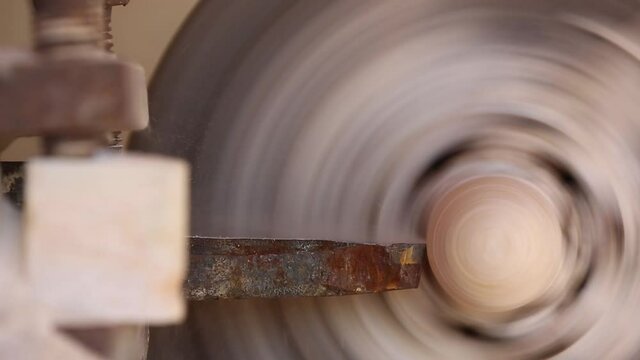 The processing of amber. Polishing and grinding pieces of amber. Making jewelry from the sun stone. Manufacturing technology amber products. Master grinds amber. Polishing wheel. Natural mineral.