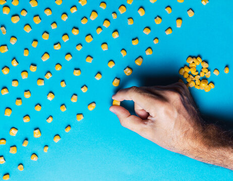 
Man with obsessive compulsive disorder placing corn kernels neatly in a row
