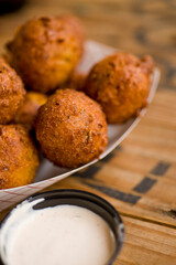 Hush puppies. Deep fried cornmeal made with onions, garlic and butter. Classic Cajun cuisine appetizer favorite. Classic New Orleans cuisine.