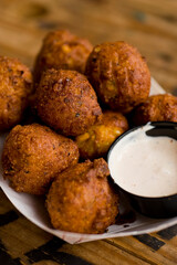 Hush puppies. Deep fried cornmeal made with onions, garlic and butter. Classic Cajun cuisine appetizer favorite. Classic New Orleans cuisine.