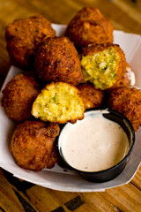 Hush puppies. Deep fried cornmeal made with onions, garlic and butter. Classic Cajun cuisine appetizer favorite. Classic New Orleans cuisine.