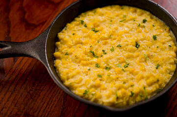 Steakhouse side dishes. Asparagus, salad, tomatoes, mashed potatoes, red onions, cream cauliflower, pickled peppers, seasoned meats served in cast iron skillet. Traditional appetizer items.