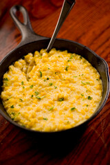 Steakhouse side dishes. Asparagus, salad, tomatoes, mashed potatoes, red onions, cream cauliflower, pickled peppers, seasoned meats served in cast iron skillet. Traditional appetizer items.