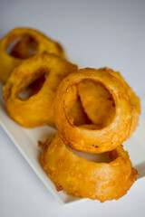 Onion rings. Yellow Spanish onion rings, battered  and deep fried in tempura batter. Classic American steakhouse appetizer.