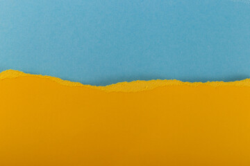 Texture of multi-colored torn paper in yellow and blue colors. Background. National symbol - the state flag of Ukraine