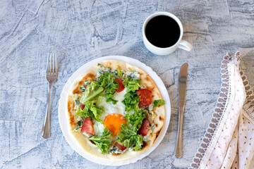 Italian breakfast with coffee. Piadina with egg, tomatoes and salad. Delicious breakfast served on table with napkin.