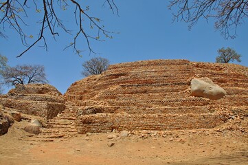 Stone, textured masonry of the walls of the ancient city against the blue sky located in Zimbabwe...