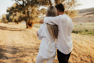 Close-up portrait of a young people walking in the park. Love and emotions. Back view.