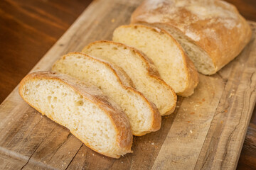 sliced artisan bread on a wooden cutting board