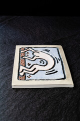 Handmade Ceramic Plates and Trays. Handcrafted with Yoga Figure Relief, on Dark Surface and Backround / Handicraft.