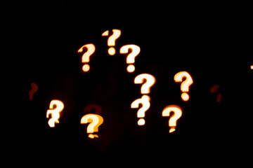 Garland in the form of a question mark glows on a black background.