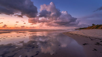  colorful sunset over the sea with beautiful clouds, reflection of clouds in the water