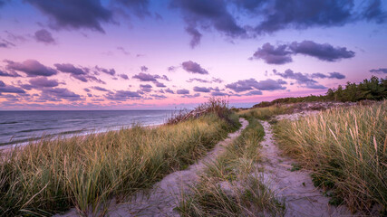 Fototapeta premium beautiful magenta sunset over the sea with sandy shore